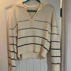 Super simple but classy cream v neck sweater with black stripes.